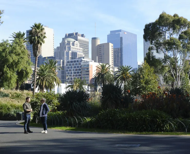 Two people talking in the gardens
