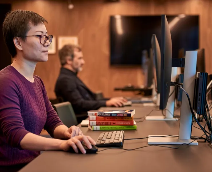 Two people sitting at desk using library computers