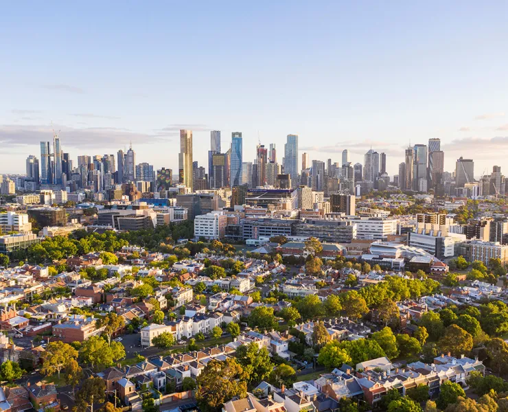 Aerial view of the Melbourne CBD skyline with a residential area in the foreground