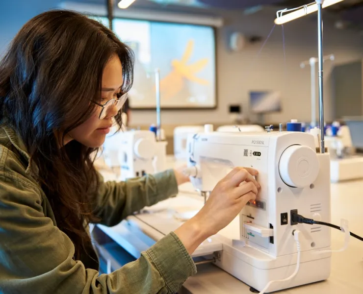 Woman using makerspace machine to craft something wonderful