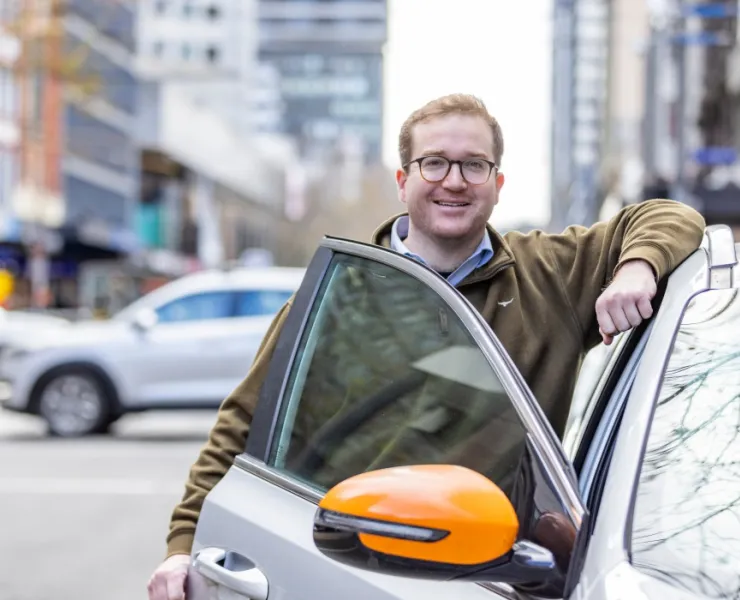 Man who just parked his car smiling at the world 