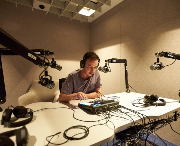 Man recording audio in studio at library