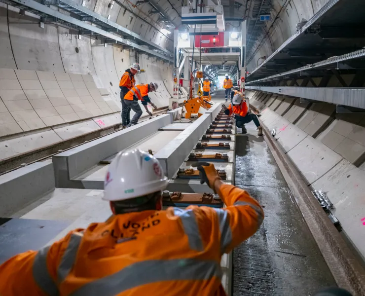 Construction workers working on the tracks for the Metro Tunnel Project.