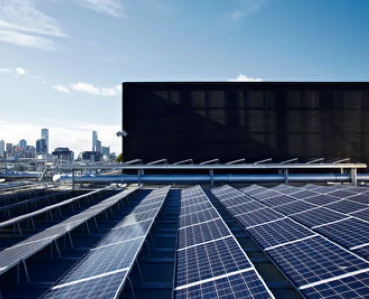 Rows of solar panels on a commercial building rooftop