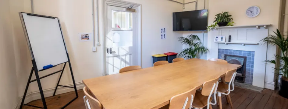 The Principal's office set up with a small wooden table and six chairs
