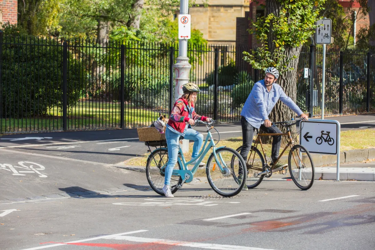 Two cyclists riding bikes on College Crescent.