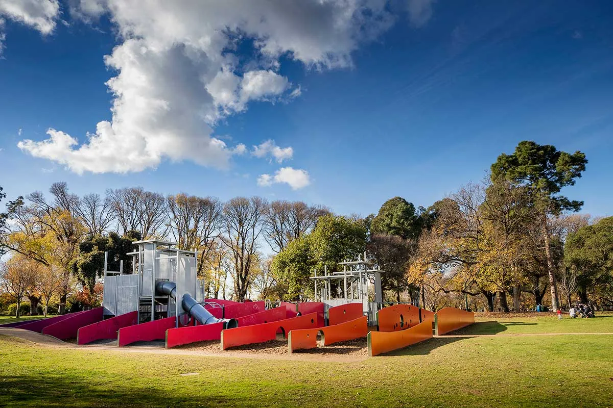 A playground with red features in a park
