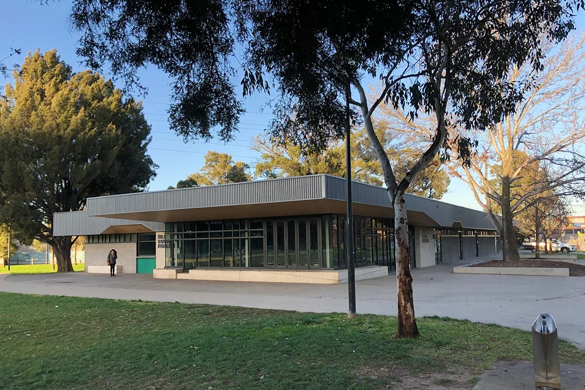 A square-shaped building in a park