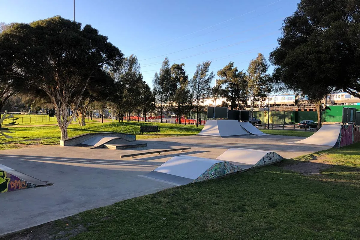A skate park with different feature in a park