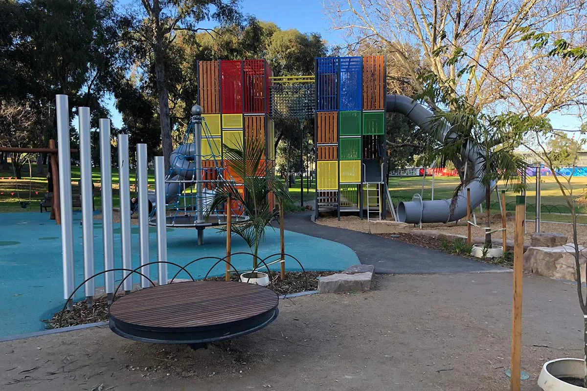  A playground with silver steel poles and a slide