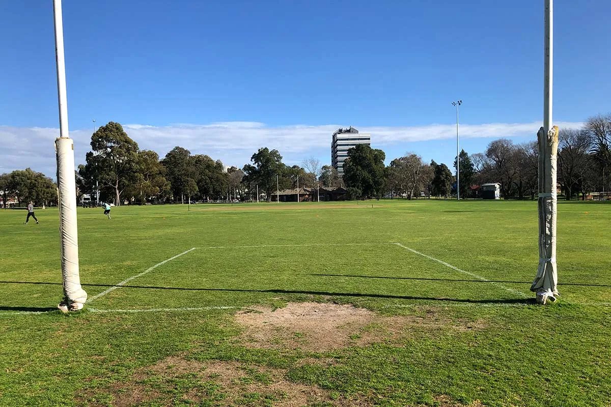 A football field viewed from between two straight goal posts