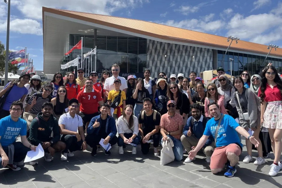 A group of people posing in front of a sports centre